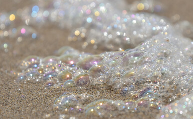 Sea foam bubbles close-up on the beach