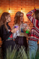 Friends celebrate a holiday in a cafe. There is artistic noise.