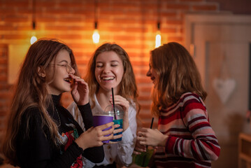 Friends celebrate a holiday in a cafe. There is artistic noise.