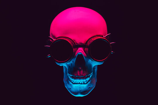 human skull in steampunk glasses with colored neon light on a black background