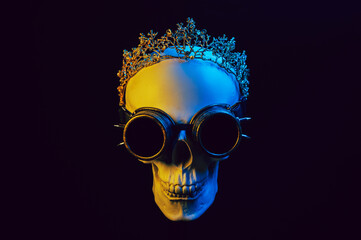 human skull in a crown and steampunk glasses with colored yellow blue neon light on a black background