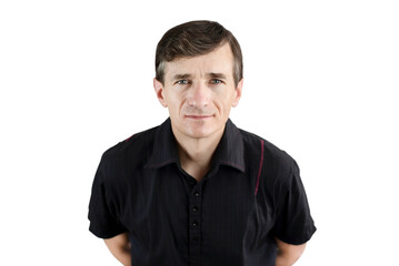 Fototapeta premium A mature man in a black t-shirt on a white background, the man has an alert look as if he is waiting for something, looking at news or a certain product, isolated