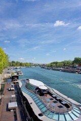 A Tourist boat on the seine river in Paris. A beautiful blue sky background on a sunny day.