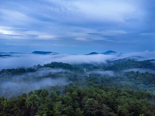 Gorgeous sunrise over the Appalachian mountain with fog surrounding it below and a blue and pink sky