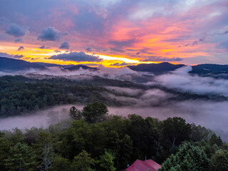 Gorgeous sunrise over the Appalachian mountain with fog surrounding it below and a blue and pink sky