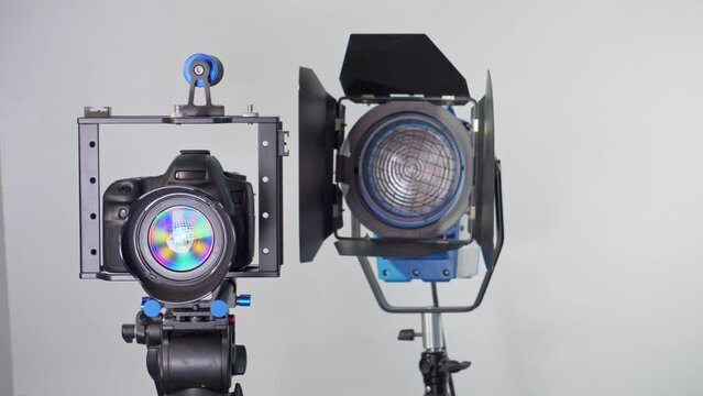 Camera in a photo studio with backdrop and light equipment