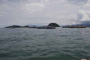 View of the sea, islands and boats and a cloudy sky in the morning