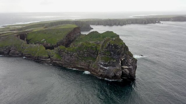 The cliffs and sea stacks An Tor Mor and the Wishing Stone at Port Challa on Tory Island, County Donegal, Ireland
