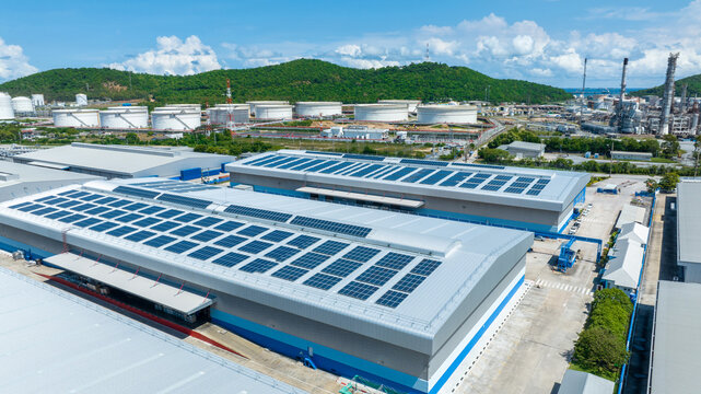 Top view Solar Cell on Warehouse Factory. Solor photo voltaic panels system power or Solar Cell on industrial building roof for producing green ecological electricity. Production of renewable energy.