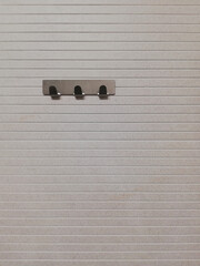 metal hooks on the wall in the toilet, empty hangers