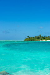 Maldives: Desert island with palms, turquoise sea and blue sky on Ari Atoll