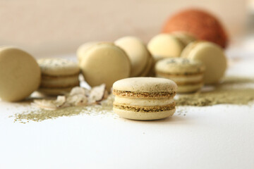 Dessert with coconut. Coconut white chocolate macaroons on a white background. Matcha tea macaroons Sweet present, cafe menu. Sweets still life.