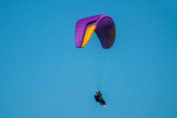 tandem paragliding at a sunny summer day in the mountains