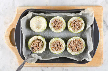 Zucchini stuffed with minced meat and rice, with tomatoes and mozzarella. Step-by-step cooking