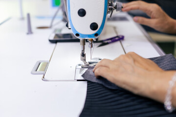 Tailor working on electric sewing machine