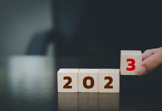 2023 new year goal planning idea, wood block cube on wooden table with new year 2023 and target icon, business vision.