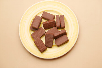 dark chocolate on a plate on table top view 