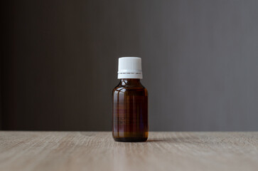 Glass jar with plastic lid. Dark glass jar. Medicine container. Pharmaceutical glassware. Chemical vessels.