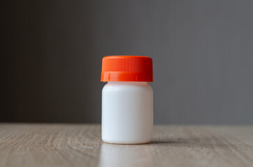 Plastic jar for pills. Medicine storage container. Pharmaceutical products. Medicine capsules.