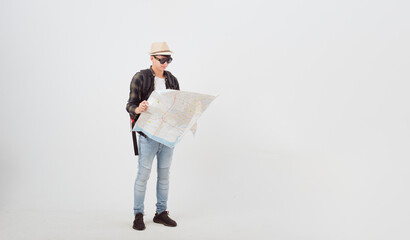 Asian young man traveler with map and backpack relaxing isolated on white background studio....