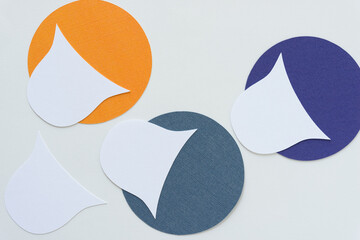 white paper shapes on colorful paper circles