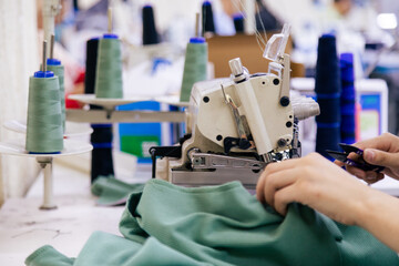 Tailor working on electric sewing machine