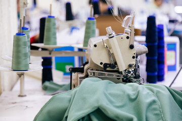 Tailor working on electric sewing machine