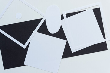 white and black paper shapes on blank paper