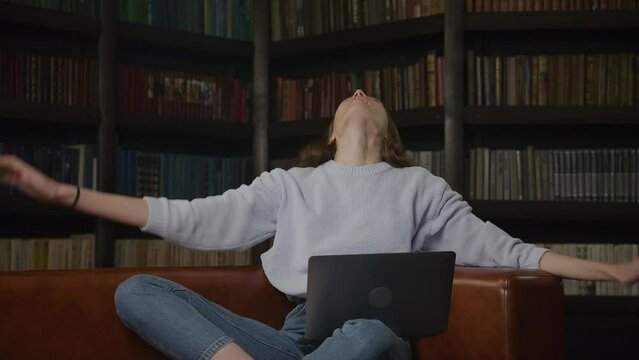 Young adult caucasian woman recieving good news on her laptop computer