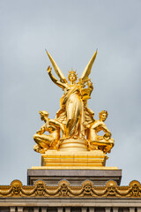 Fototapeta na wymiar Winged golden statues atop the paris opera house paris Music on top of Opera Garnier 