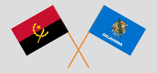 Crossed flags of Angola and The State of Oklahoma. Official colors. Correct proportion