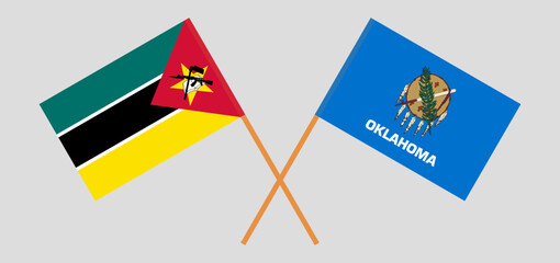 Crossed flags of Mozambique and The State of Oklahoma. Official colors. Correct proportion