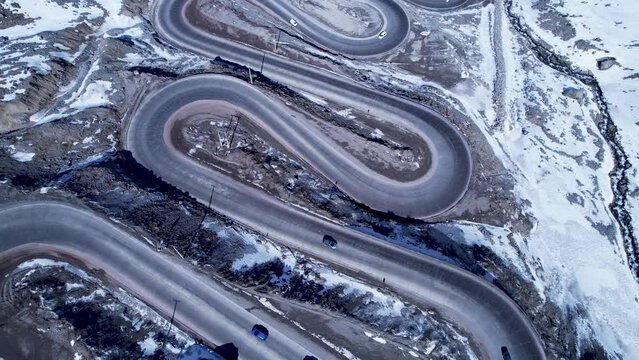 Highway road with scenic curves winding road at Andes Mountains. Los Caracoles highway road near Santiago Chile. Snowing scenery. Snowing road. Curves background. Curves road.