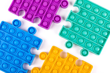 Set of popular colorful fidget toys pop it on blue background. New sensory antistress toys for...