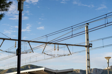 Railway catenary against blue sky