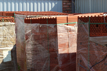 Red ceramic bricks in packaging at a construction site. Keramoblock. Good quality