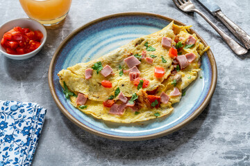 Egg omelette with ham, mushrooms and tomatoes