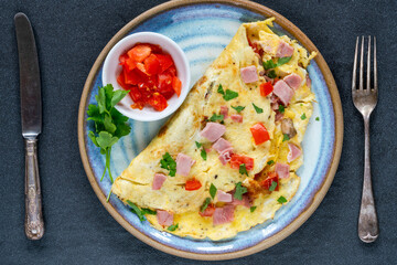 Egg omelette with ham, mushrooms and tomatoes