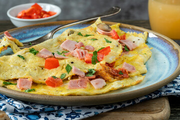 Egg omelette with ham, mushrooms and tomatoes