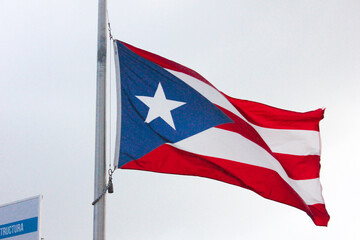 Puerto Rico state flag fly with blue sky in San Juan.