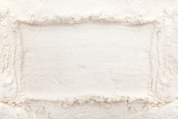 Background from wheat flour. Texture of flour with a free space in the form of a frame for the inscription