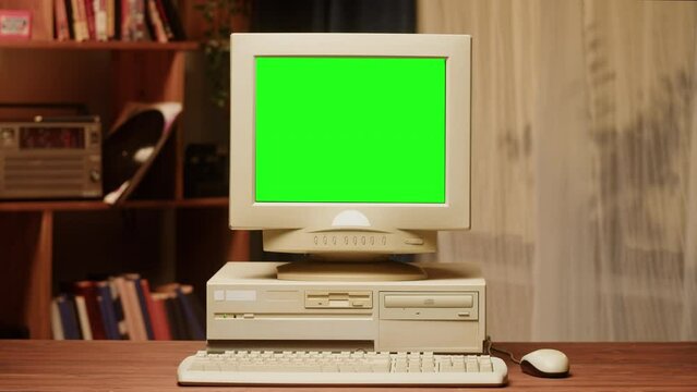 Old computer with green chroma key screen close-up, Desktop PC. Retro room, obsolete technology. 