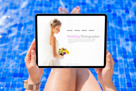 Woman viewing website of a wedding photographer on tablet computer