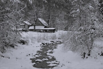 Kleine Hütte an einem Bach im Winter in der Schweiz