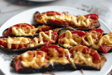 Fried eggplant with tomatoes and cheese. Georgian eggplant