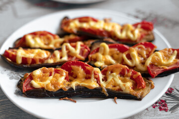 Fried eggplant with tomatoes and cheese. Georgian eggplant