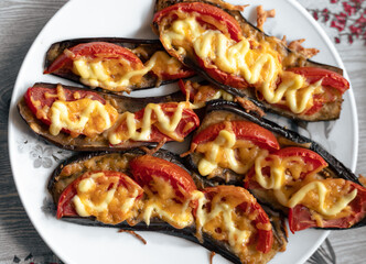 Fried eggplant with tomatoes and cheese. Georgian eggplant