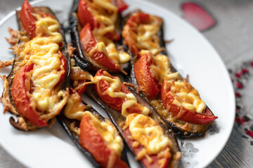 Fried eggplant with tomatoes and cheese. Georgian eggplant