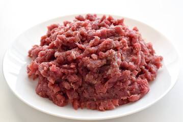 Raw minced beef or ground beef on a white plate.