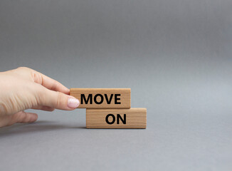 Move on symbol. Wooden blocks with words Move on. Beautiful grey background. Businessman hand. Business and Move on concept. Copy space.